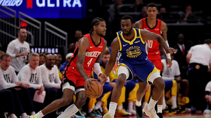 Nov 2, 2024; Houston, Texas, USA; Houston Rockets guard Jalen Green (4) handles the ball against Golden State Warriors forward Andrew Wiggins (22) during the first quarter at Toyota Center. Mandatory Credit: Erik Williams-Imagn Images
