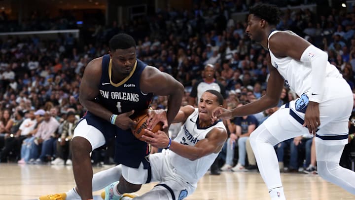 Oct 25, 2023; Memphis, Tennessee, USA; New Orleans Pelicans forward Zion Williamson (1) looses control of the ball as Memphis Grizzlies guard Desmond Bane (22) and forward-center Jaren Jackson Jr. (13) defends during the second half at FedExForum. Mandatory Credit: Petre Thomas-Imagn Images