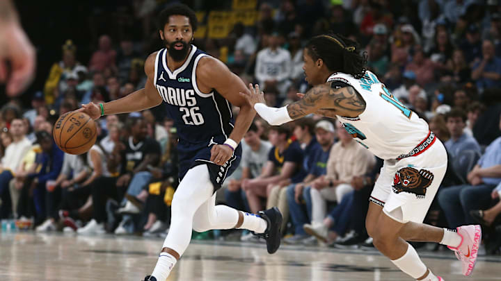 Apr 18, 2025; Memphis, Tennessee, USA; Dallas Mavericks guard Spencer Dinwiddie (26) dribbles against Memphis Grizzlies guard Ja Morant (12) during the second quarter at FedExForum. Mandatory Credit: Petre Thomas-Imagn Images