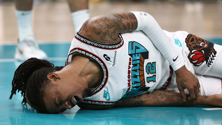 Apr 24, 2025; Memphis, Tennessee, USA; Memphis Grizzlies guard Ja Morant (12) lays on the court after being fouled during the second quarter against the Oklahoma City Thunder during game three for the first round of the 2024 NBA Playoffs at FedExForum. Mandatory Credit: Petre Thomas-Imagn Images Apr 24, 2025; Memphis, Tennessee, USA; Memphis Grizzlies guard Ja Morant (12) lays on the court after being fouled during the second quarter against the Oklahoma City Thunder during game three for the first round of the 2024 NBA Playoffs at FedExForum. Mandatory Credit: Petre Thomas-Imagn Images
