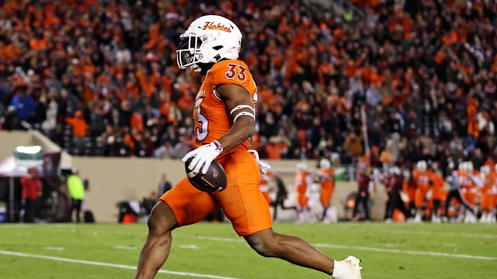 Oct 17, 2024; Blacksburg, Virginia, USA; Virginia Tech Hokies running back Bhayshul Tuten (33) scores a touchdown during the fourth quarter against the Boston College Eagles at Lane Stadium. Mandatory Credit: Peter Casey-Imagn Images