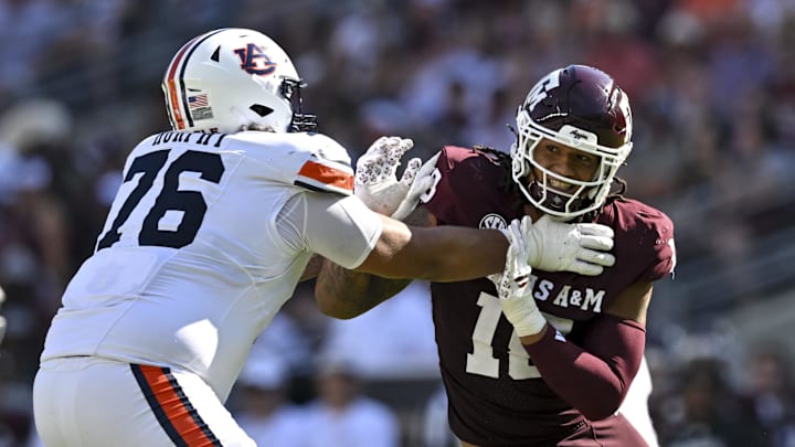Sep 27, 2025; College Station, Texas, USA; Texas A&M Aggies defensive end T.J. Searcy (18) defends in coverage as Auburn Tigers offensive lineman Mason Murphy (76) attempts to block during the second quarter at Kyle Field. Mandatory Credit: Maria Lysaker-Imagn Images Sep 27, 2025; College Station, Texas, USA; Texas A&M Aggies defensive end T.J. Searcy (18) defends in coverage as Auburn Tigers offensive lineman Mason Murphy (76) attempts to block during the second quarter at Kyle Field. Mandatory Credit: Maria Lysaker-Imagn Images