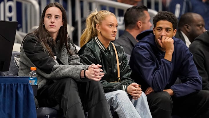 Indiana Fever Caitlin Clark (22) watches the game from the sidelines on Monday, Nov. 11, 2024, during the game at Hinkle Fieldhouse in Indianapolis. The Butler Bulldogs defeated the Western Michigan Broncos, 85-65.