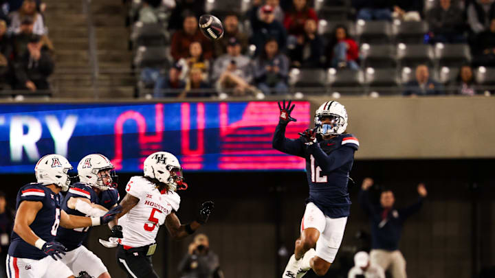 Nov 15, 2024; Tucson, Arizona, USA; Arizona Wildcats defensive back Genesis Smith (12) intercepts the ball during the second quarter against the Houston Cougars at Arizona Stadium. Mandatory Credit: Aryanna Frank-Imagn Images