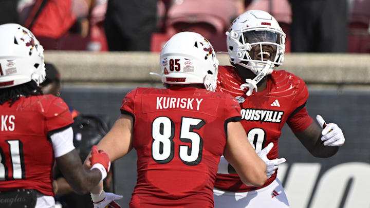 Sep 21, 2024; Louisville, Kentucky, USA;  Louisville Cardinals wide receiver Chris Bell (0) celebrates a touchdown with tight end Nate Kurisky (85) during the first half against the Georgia Tech Yellow Jackets at L&N Federal Credit Union Stadium. Mandatory Credit: Jamie Rhodes-Imagn Images