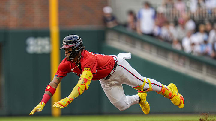 Jul 18, 2025; Cumberland, Georgia, USA; Atlanta Braves right fielder Ronald Acuna Jr (13) slides into second base after hitting a double to drive in a run against the New York Yankees during the first inning at Truist Park. Mandatory Credit: Dale Zanine-Imagn Images