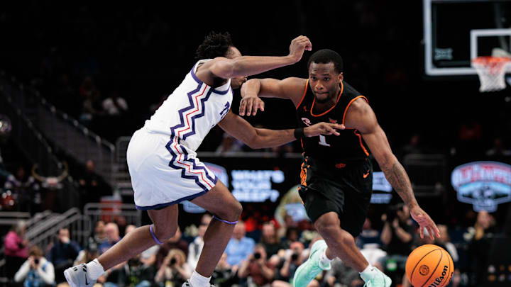 Mar 11, 2026; Kansas City, MO, USA; Oklahoma State Cowboys guard Kanye Clary (1) drives around TCU Horned Frogs guard Jayden Pierre (1) during the second half at T-Mobile Center. Mandatory Credit: William Purnell-Imagn Images