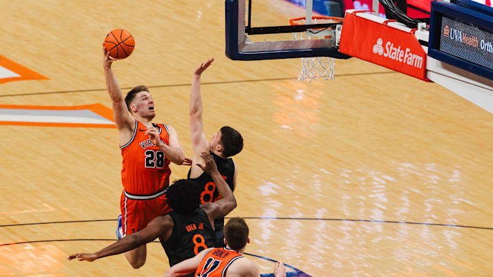 Feb 21, 2026; Charlottesville, Virginia, USA; Virginia Cavaliers forward Thijs de Ridder (28) shoots the ball while Miami (FL) Hurricanes forward Timo Malovec (88) defends during the second half at John Paul Jones Arena. Mandatory Credit: Emily Faith Morgan-Imagn Images