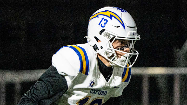 Oxford quarterback Knox Kiffin (13) carries the ball during a high school football game. Oxford quarterback Knox Kiffin (13) carries the ball during a high school football game.