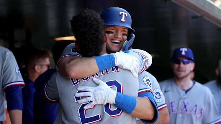 Texas Rangers third baseman Josh Jung hugs Ezequiel Duran in celebration.
