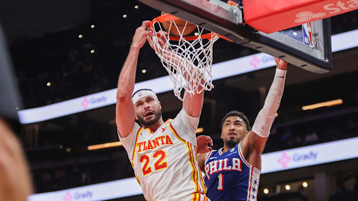 Oct 14, 2024; Atlanta, Georgia, USA; Atlanta Hawks forward Larry Nance Jr. (22) is fouled by Philadelphia 76ers forward KJ Martin (1) in the fourth quarter at State Farm Arena. Mandatory Credit: Brett Davis-Imagn Images
