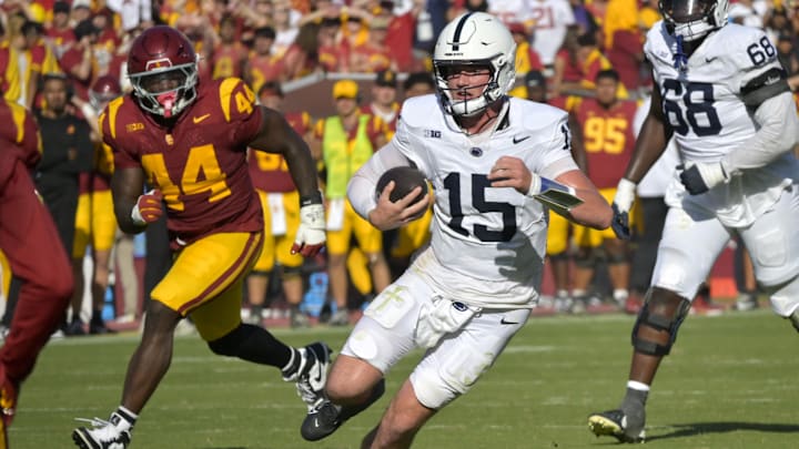 Penn State quarterback Drew Allar carries the ball for a short gain against the USC Trojans at the Los Angeles Memorial Coliseum.