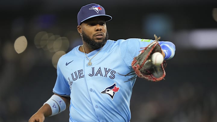 Mar 30, 2025; Toronto, Ontario, CAN; Toronto Blue Jays first baseman Vladimir Guerrero (27) catches a ball thrown to them at the end of the first inning against the Baltimore Orioles at Rogers Centre. Mandatory Credit: John E. Sokolowski-Imagn Images Mar 30, 2025; Toronto, Ontario, CAN; Toronto Blue Jays first baseman Vladimir Guerrero (27) catches a ball thrown to them at the end of the first inning against the Baltimore Orioles at Rogers Centre. Mandatory Credit: John E. Sokolowski-Imagn Images