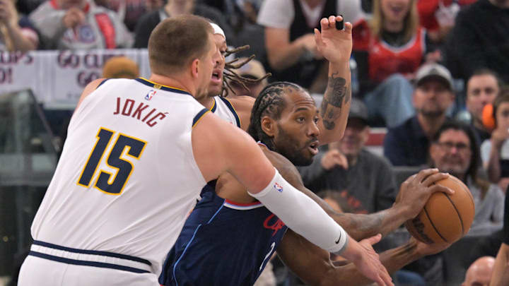 Apr 26, 2025; Inglewood, California, USA; Los Angeles Clippers forward Kawhi Leonard (2) is defended by Denver Nuggets center Nikola Jokic (15) and forward Aaron Gordon (32) as he drives to the basket in the first half of game four of round one of the 2024 NBA Playoffs at Intuit Dome. Mandatory Credit: Jayne Kamin-Oncea-Imagn Images Apr 26, 2025; Inglewood, California, USA; Los Angeles Clippers forward Kawhi Leonard (2) is defended by Denver Nuggets center Nikola Jokic (15) and forward Aaron Gordon (32) as he drives to the basket in the first half of game four of round one of the 2024 NBA Playoffs at Intuit Dome. Mandatory Credit: Jayne Kamin-Oncea-Imagn Images