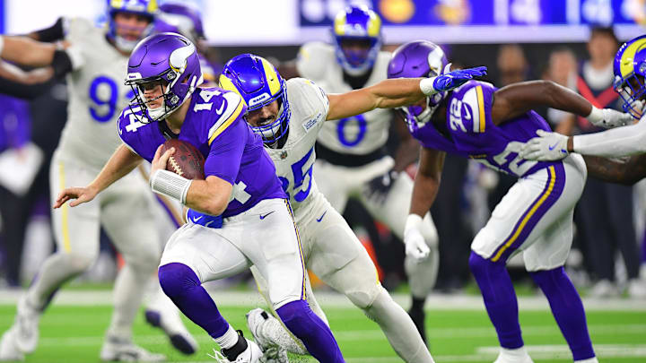 Oct 24, 2024; Inglewood, California, USA; Minnesota Vikings quarterback Sam Darnold (14) runs the ball from Los Angeles Rams linebacker Jacob Hummel (35) during the first half at SoFi Stadium. Mandatory Credit: Gary A. Vasquez-Imagn Images
