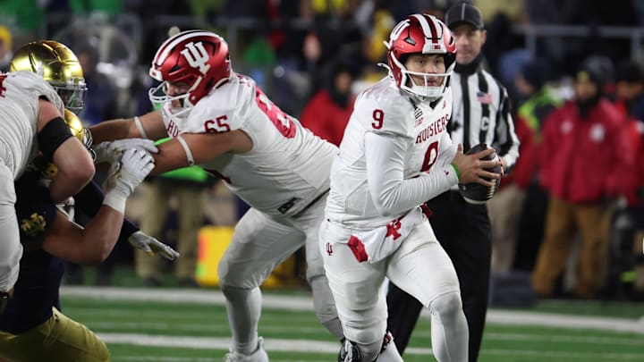 Dec 20, 2024; Notre Dame, Indiana, USA; Indiana Hoosiers quarterback Kurtis Rourke (9) scrambles during the second half against the Notre Dame Fighting Irish at Notre Dame Stadium. Mandatory Credit: Trevor Ruszkowski-Imagn Images