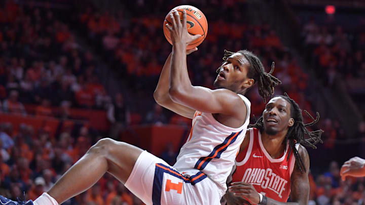 Feb 2, 2025; Champaign, Illinois, USA; Illinois Fighting Illini forward Morez Johnson Jr. (21) pulls down a rebound during the first half against the Ohio State Buckeyes at State Farm Center. Mandatory Credit: Ron Johnson-Imagn Images