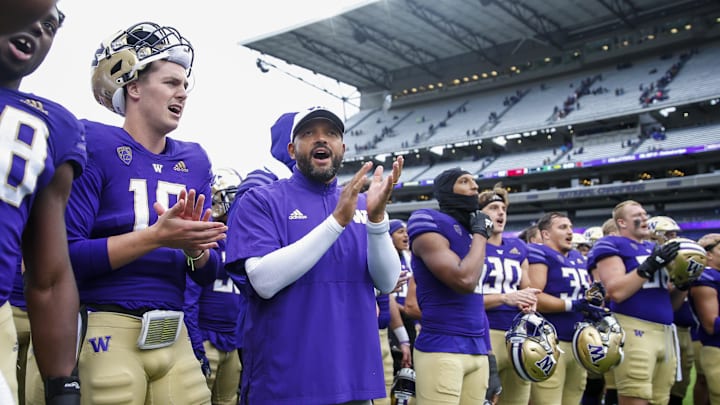 Jimmy Lake stands next to UW quarterback Patrick O'Brien (10) in 2021 as the Huskies celebrate a win over Arkansas State. Jimmy Lake stands next to UW quarterback Patrick O'Brien (10) in 2021 as the Huskies celebrate a win over Arkansas State.