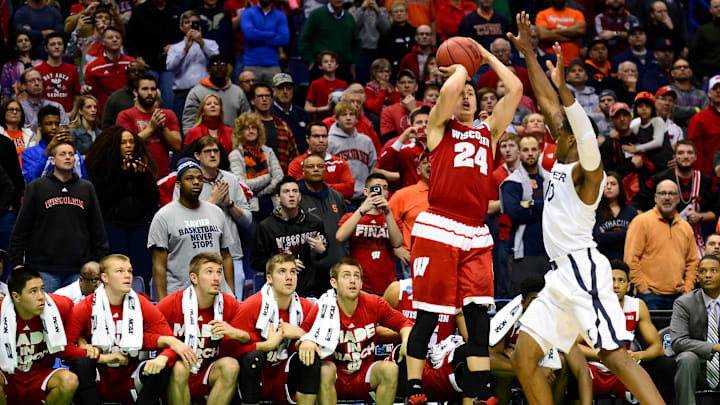 Mar 20, 2016; St. Louis, MO, USA; Wisconsin Badgers guard Bronson Koenig (24) shoots the game-winning shot over Xavier Musketeers guard Remy Abell (10) during the second half of the second round in the 2016 NCAA Tournament at Scottrade Center. Wisconsin won 66-63. 