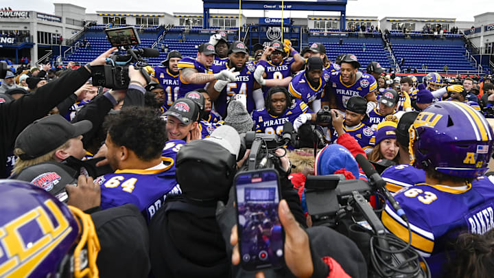 Dec 27, 2025; Annapolis, MD, USA;  East Carolina Pirates celebrate on the stage after defeating the Pittsburgh Panthers to win the Military Bowl at Navy-Marine Corps Stadium. Mandatory Credit: Tommy Gilligan-Imagn Images