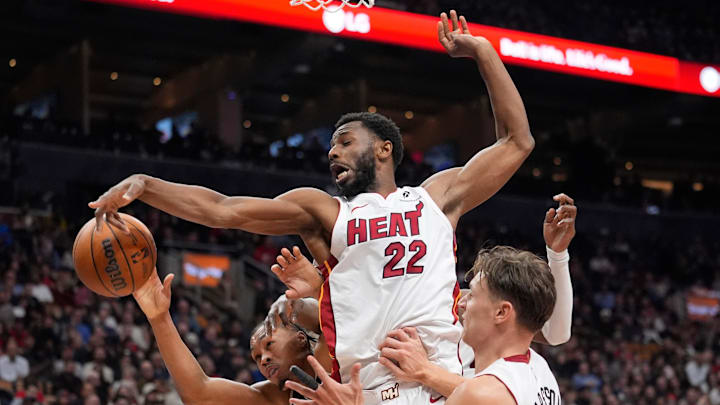 Apr 9, 2026; Toronto, Ontario, CAN; Miami Heat forward Andrew Wiggins (22) vies for a rebound against Toronto Raptors guard Scottie Barnes (4) during the second half at Scotiabank Arena. Mandatory Credit: John E. Sokolowski-Imagn Images