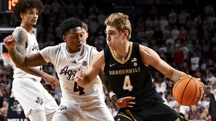 Feb 26, 2025; College Station, Texas, USA; Vanderbilt Commodores guard Grant Huffman (4) drives against Texas A&M Aggies guard Wade Taylor IV (4) during the second half at Reed Arena. Mandatory Credit: Maria Lysaker-Imagn Images 