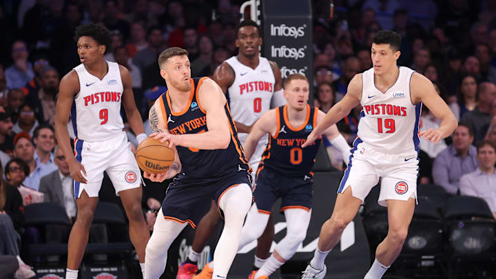 Feb 26, 2024; New York, New York, USA; New York Knicks center Isaiah Hartenstein (55) looks to pass the ball against Detroit Pistons forward Ausar Thompson (9) and center Jalen Duren (0) and forward Simone Fontecchio (19) during the first quarter at Madison Square Garden. Mandatory Credit: Brad Penner-Imagn Images
