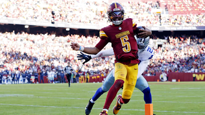 Nov 24, 2024; Landover, Maryland, USA; Washington Commanders quarterback Jayden Daniels (5) runs for a touchdown against Dallas Cowboys safety Malik Hooker (28) during the third quarter at Northwest Stadium. Mandatory Credit: Peter Casey-Imagn Images Nov 24, 2024; Landover, Maryland, USA; Washington Commanders quarterback Jayden Daniels (5) runs for a touchdown against Dallas Cowboys safety Malik Hooker (28) during the third quarter at Northwest Stadium. Mandatory Credit: Peter Casey-Imagn Images