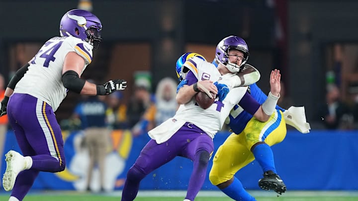 Jan 13, 2025; Glendale, AZ, USA; Los Angeles Rams defensive tackle Neville Gallimore (92) sacks Minnesota Vikings quarterback Sam Darnold (14) during the second half in an NFC wild card game at State Farm Stadium. Mandatory Credit: Joe Camporeale-Imagn Images