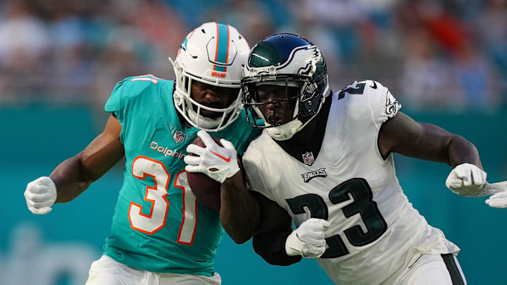 Philadelphia Eagles safety Jaquiski Tartt (23) and Miami Dolphins running back Raheem Mostert (31)