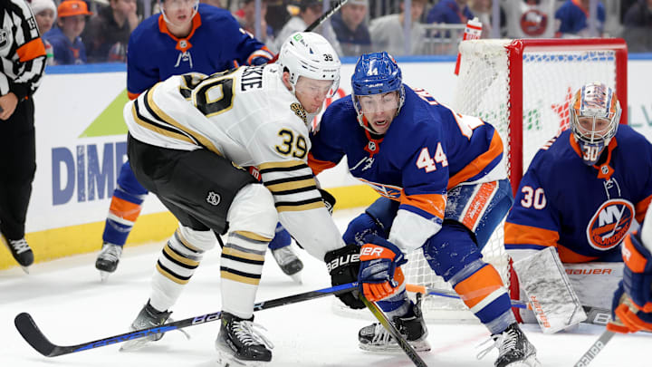 Dec 15, 2023; Elmont, New York, USA; Boston Bruins center Morgan Geekie (39) fights for the puck