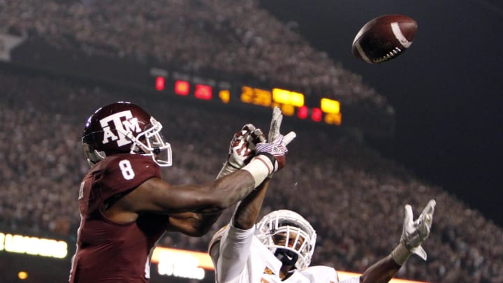 Nov 24, 2011; College Station, TX, USA; Texas Longhorns cornerback Eddie Aboussie (23) breaks up a pass intended for Texas A&M Aggies  wide receiver Jeff Fuller (8) in the fourth quarter at Kyle Field. Texas defeated Texas A&M 27-25.  Mandatory Credit: Brett Davis-USA TODAY Sports