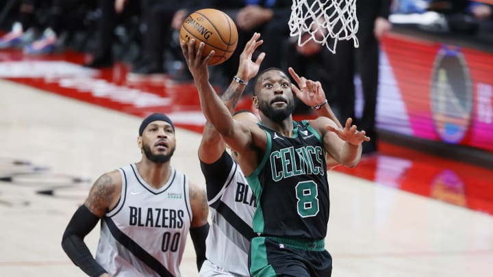 Apr 13, 2021; Portland, Oregon, USA; Boston Celtics point guard Kemba Walker (8) goes to the basket past Portland Trail Blazers small forward Norman Powell (24) during the second half at Moda Center. Mandatory Credit: Soobum Im-USA TODAY Sports