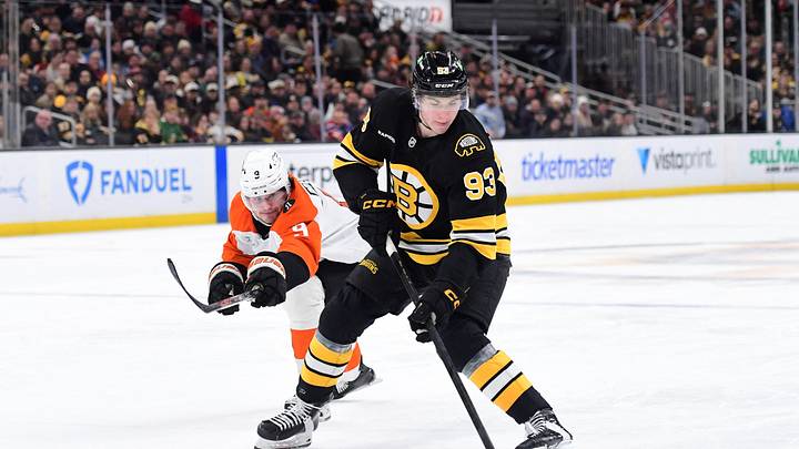 Jan 29, 2026; Boston, Massachusetts, USA; Boston Bruins center Fraser Minten (93) controls the puck from Philadelphia Flyers defenseman Jamie Drysdale (9) during the third period at TD Garden. Mandatory Credit: Bob DeChiara-Imagn Images