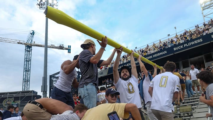 Georgia Tech fans take down a goal post after he win over Miami