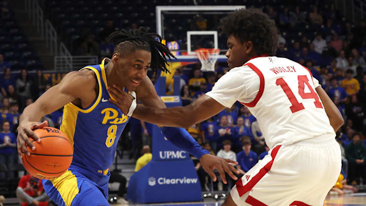 Jan 17, 2026; Pittsburgh, Pennsylvania, USA;  Pittsburgh Panthers guard Omari Witherspoon (8) drives to the basket against Louisville Cardinals guard Adrian Wooley (14) during the first half at the Petersen Events Center. Mandatory Credit: Charles LeClaire-Imagn Images