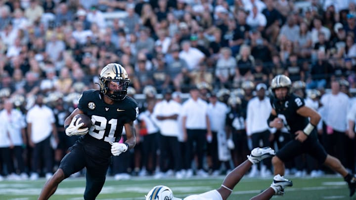 Vanderbilt wide receiver Kayleb Barnett (81) eludes the tackle of Charleston Southern safety Chandler Perry (13) before running in a touchdown during their game at FirstBank Stadium in Nashville, Tenn., Saturday, Aug. 30, 2025. Vanderbilt wide receiver Kayleb Barnett (81) eludes the tackle of Charleston Southern safety Chandler Perry (13) before running in a touchdown during their game at FirstBank Stadium in Nashville, Tenn., Saturday, Aug. 30, 2025.