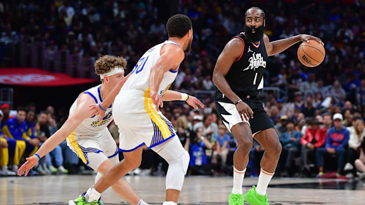 Los Angeles Clippers guard James Harden (1) controls the ball against Golden State Warriors guard Stephen Curry (30) and guard Brandin Podziemski (2) during the second half at Crypto.com Arena. Mandatory Credit: Gary A. Vasquez-Imagn Images