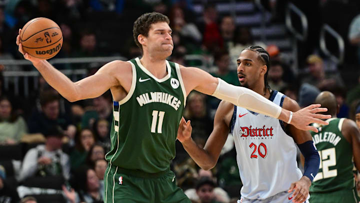 Dec 21, 2024; Milwaukee, Wisconsin, USA; Milwaukee Bucks center Brook Lopez (11) controls the ball against Washington Wizards center Alex Sarr (20) in the third quarter at Fiserv Forum. Mandatory Credit: Benny Sieu-Imagn Images Dec 21, 2024; Milwaukee, Wisconsin, USA; Milwaukee Bucks center Brook Lopez (11) controls the ball against Washington Wizards center Alex Sarr (20) in the third quarter at Fiserv Forum. Mandatory Credit: Benny Sieu-Imagn Images