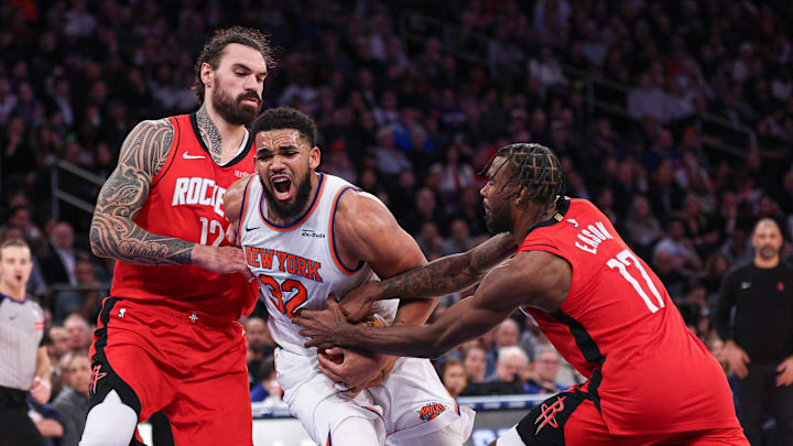 Feb 3, 2025; New York, New York, USA; New York Knicks center Karl-Anthony Towns (32) goes to the basket as Houston Rockets forward Tari Eason (17) and center Steven Adams (12) defend during the second half at Madison Square Garden. Mandatory Credit: Vincent Carchietta-Imagn Images