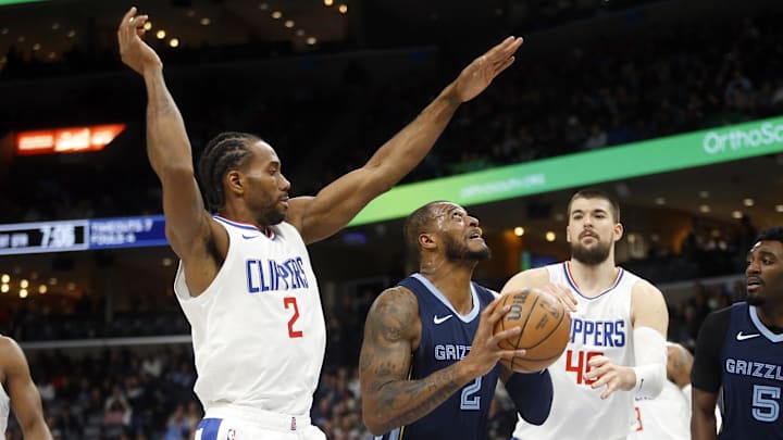 Jan 12, 2024; Memphis, Tennessee, USA; Memphis Grizzlies forward Xavier Tillman (2) drives to the basket between Los Angeles Clippers forward Kawhi Leonard (2) and center Ivica Zubac (40) during the first half at FedExForum. Mandatory Credit: Petre Thomas-Imagn Images