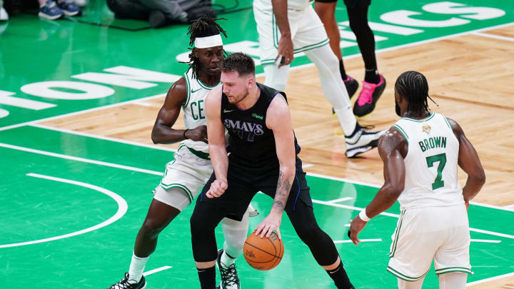 Jun 6, 2024; Boston, Massachusetts, USA; Dallas Mavericks guard Luka Doncic (77) controls the ball against Boston Celtics guard Jrue Holiday (4) in the second quarter during game one of the 2024 NBA Finals at TD Garden. Mandatory Credit: David Butler II-USA TODAY Sports Jun 6, 2024; Boston, Massachusetts, USA; Dallas Mavericks guard Luka Doncic (77) controls the ball against Boston Celtics guard Jrue Holiday (4) in the second quarter during game one of the 2024 NBA Finals at TD Garden. Mandatory Credit: David Butler II-USA TODAY Sports
