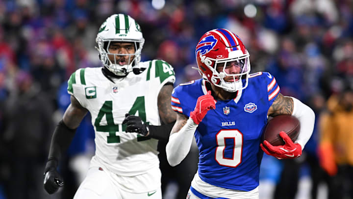 Jan 4, 2026; Orchard Park, New York, USA; Buffalo Bills wide receiver Keon Coleman (0) carries the ball after a reception defended by New York Jets linebacker Jamien Sherwood (44) during the third quarter at Highmark Stadium. Mandatory Credit: Mark Konezny-Imagn Images