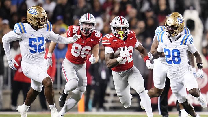 Ohio State Buckeyes running back Isaiah West (32) runs past UCLA Bruins defensive back Scooter Jackson (28) during the NCAA football game at Ohio Stadium in Columbus on Nov. 15, 2025.