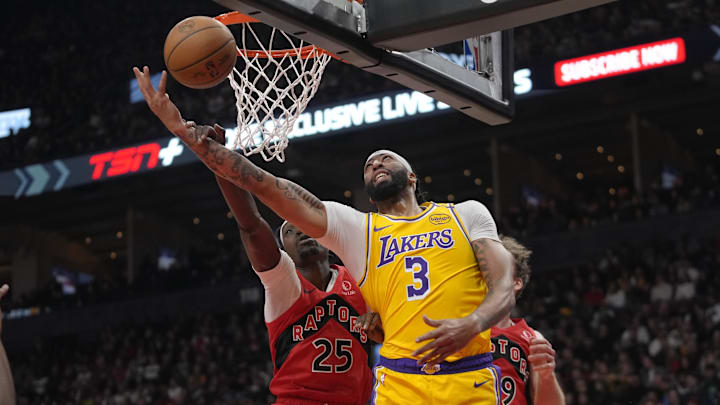 Nov 1, 2024; Toronto, Ontario, CAN; Los Angeles Lakers forward Anthony Davis (3) gets fouled by Toronto Raptors forward Chris Boucher (25) as he goes to make a basket during the first half at Scotiabank Arena. Mandatory Credit: John E. Sokolowski-Imagn Images