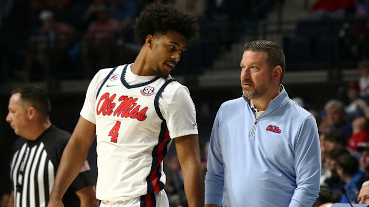 Jan 4, 2025; Oxford, Mississippi, USA; Mississippi Rebels head coach Chris Beard (right) talks with forward Jaemyn Brakefield (4) during the second half against the Georgia Bulldogs at The Sandy and John Black Pavilion at Ole Miss. Mandatory Credit: Petre Thomas-Imagn Images