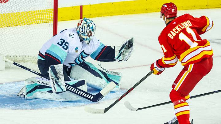 Oct 1, 2026; Calgary, Alberta, CAN; Seattle Kraken goaltender Joey Daccord (35) makes a save against Calgary Flames center Mikael Backlund (11) during the first period at Scotiabank Saddledome. Mandatory Credit: Sergei Belski-Imagn Images Oct 1, 2026; Calgary, Alberta, CAN; Seattle Kraken goaltender Joey Daccord (35) makes a save against Calgary Flames center Mikael Backlund (11) during the first period at Scotiabank Saddledome. Mandatory Credit: Sergei Belski-Imagn Images