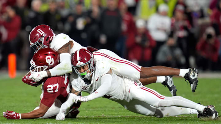 Oklahoma Sooners running back Gavin Sawchuk (27) is brought down by Alabama Crimson Tide linebacker Jihaad Campbell (11) and defensive back Domani Jackson (1) during a college football game between the University of Oklahoma Sooners (OU) and the Alabama Crimson Tide at Gaylord Family - Oklahoma Memorial Stadium in Norman, Okla., Saturday, Nov. 23, 2024. Oklahoma won 24-3. Oklahoma Sooners running back Gavin Sawchuk (27) is brought down by Alabama Crimson Tide linebacker Jihaad Campbell (11) and defensive back Domani Jackson (1) during a college football game between the University of Oklahoma Sooners (OU) and the Alabama Crimson Tide at Gaylord Family - Oklahoma Memorial Stadium in Norman, Okla., Saturday, Nov. 23, 2024. Oklahoma won 24-3.