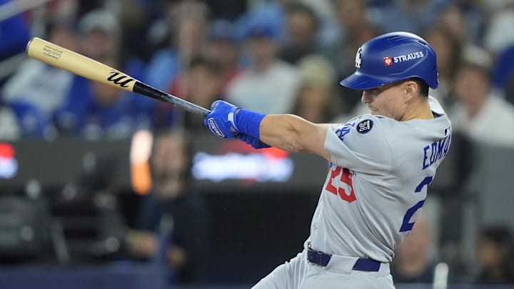 Oct 31, 2025; Toronto, Ontario, CAN; Los Angeles Dodgers second baseman Tommy Edman (25) hits a double in the third inning against the Toronto Blue Jays during game six of the 2025 MLB World Series at Rogers Centre. Mandatory Credit: John E. Sokolowski-Imagn Images Oct 31, 2025; Toronto, Ontario, CAN; Los Angeles Dodgers second baseman Tommy Edman (25) hits a double in the third inning against the Toronto Blue Jays during game six of the 2025 MLB World Series at Rogers Centre. Mandatory Credit: John E. Sokolowski-Imagn Images