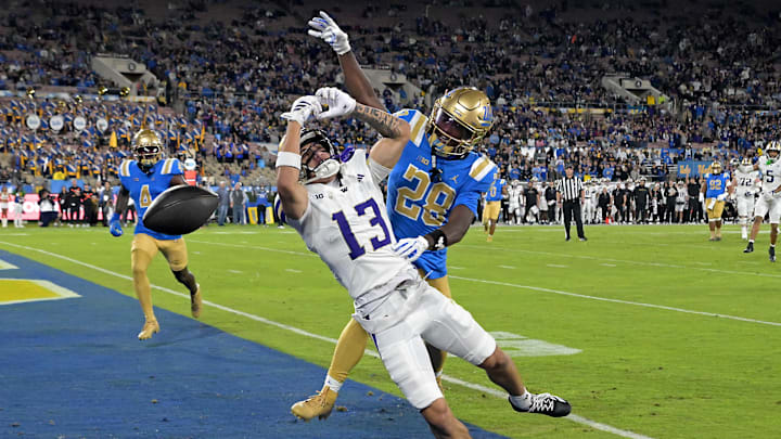 Nov 22, 2025; Pasadena, California, USA;  UCLA Bruins defensive back Scooter Jackson (28) breaks up a pass intended for Washington Huskies wide receiver Audric Harris (13) in the end zone during the first half at the Rose Bowl. Mandatory Credit: Jayne Kamin-Oncea-Imagn Images